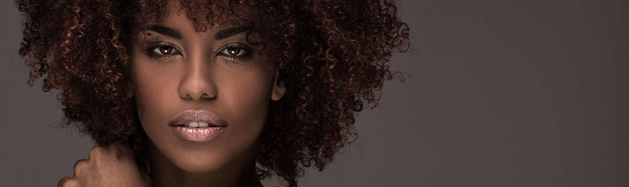Moisturize and Style with Komaza's Hair Care Essentials, Gorgeous young black woman with curly hair